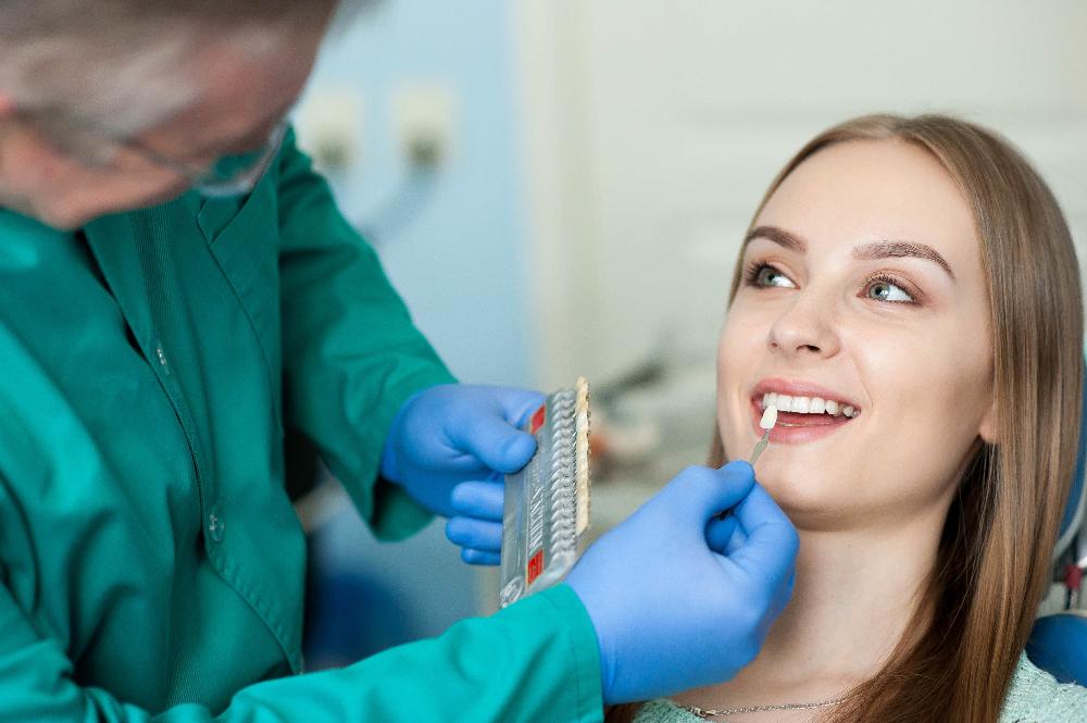 woman picking tooth shade | teeth whitening centennial co