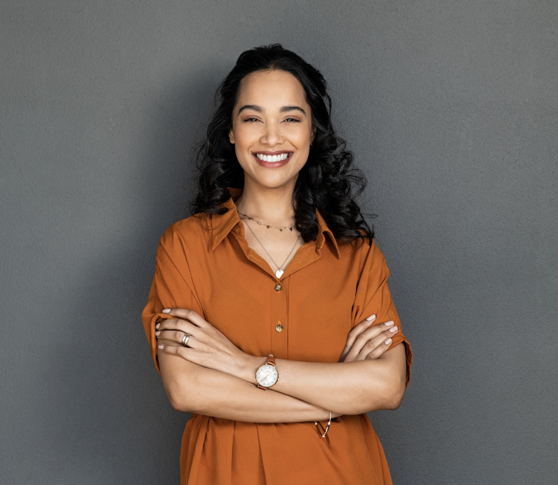woman in orange dress smiling | dentist centennial co
