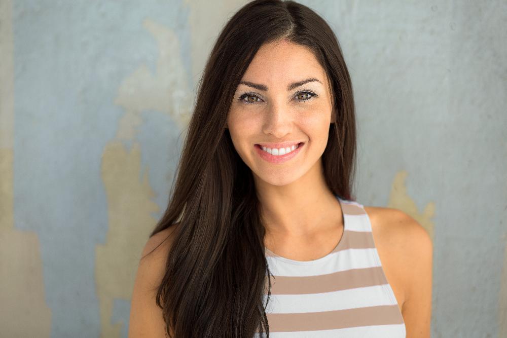 woman with long hair smiling | smile makeover centennial co