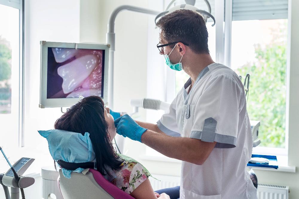 dentist looking at dentist x-ray | dental cleanings centennial co