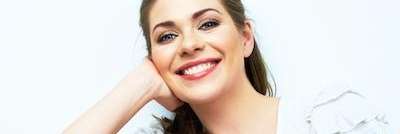 woman in white smiling | dentist centennial