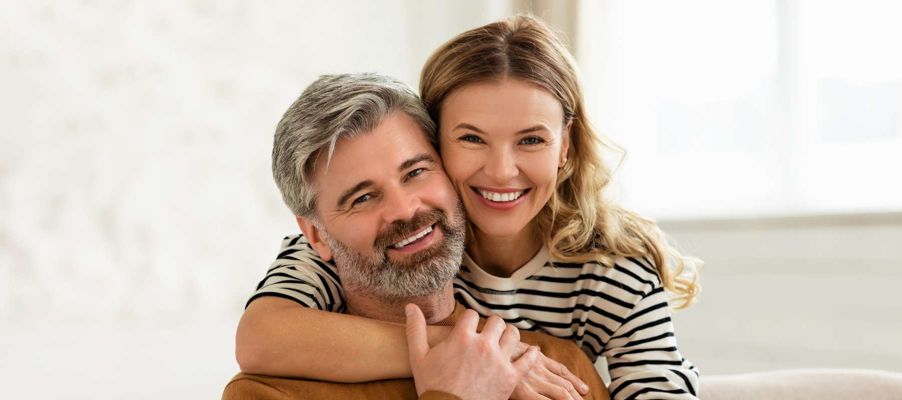 married couple smiling at the dentist in centennial