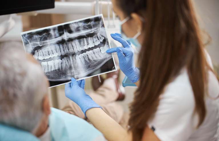 dentist showing patient x-rays in centennial