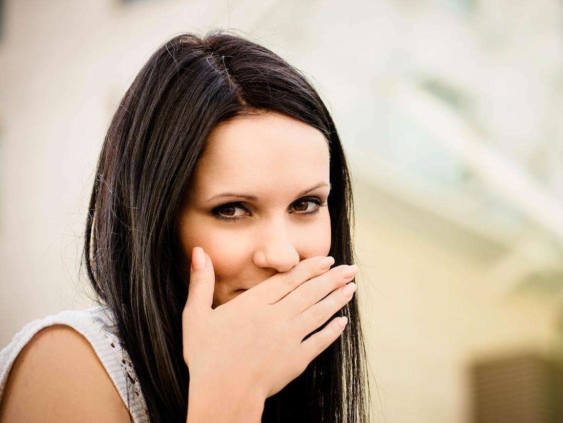 woman ashamed of yellow teeth centennial