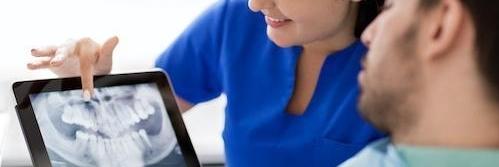 dentist looking at x-ray | dental office centennial co